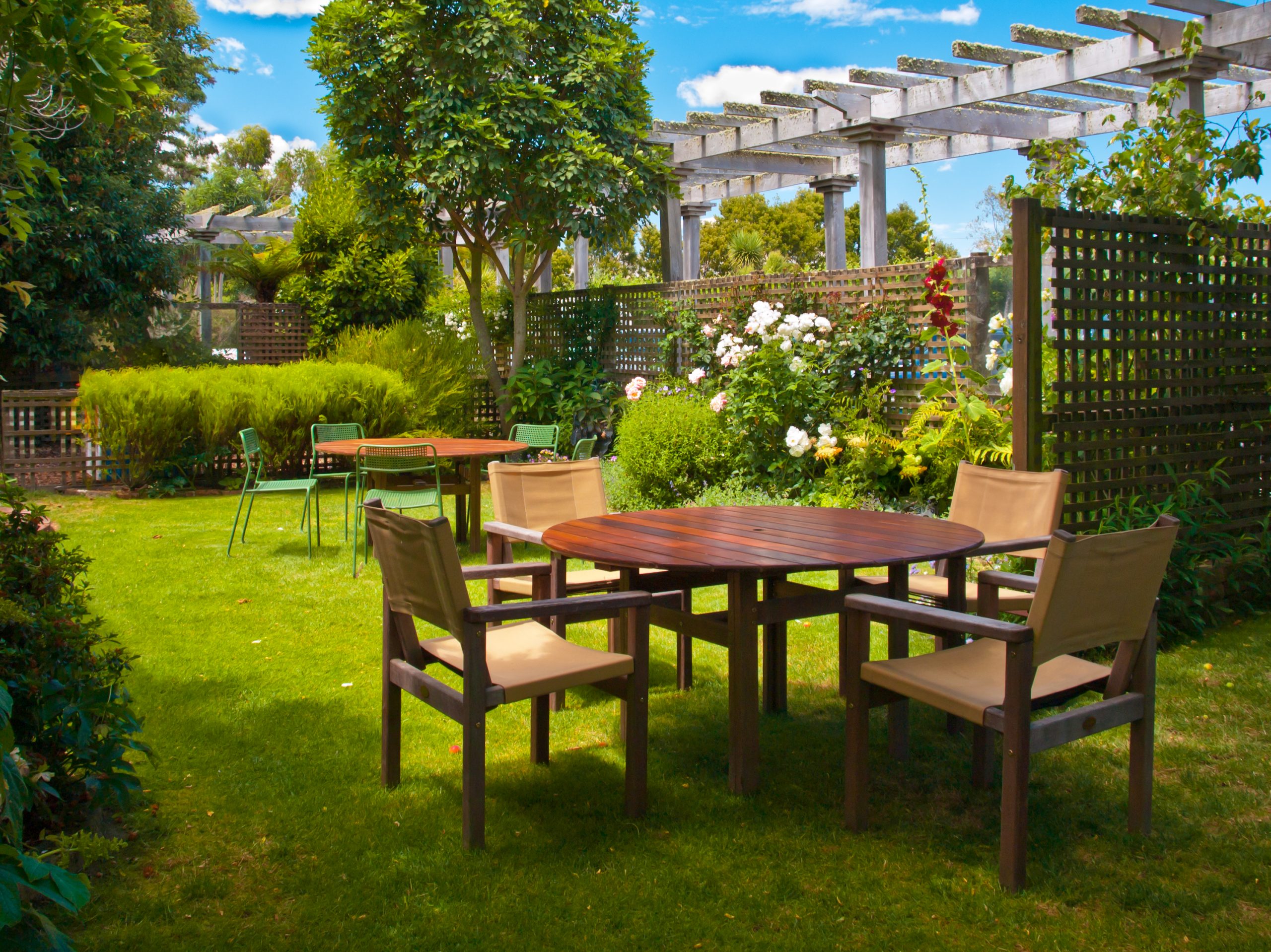 Landscaped Garden with Wooden Dining Table Set in the Shade of Trees