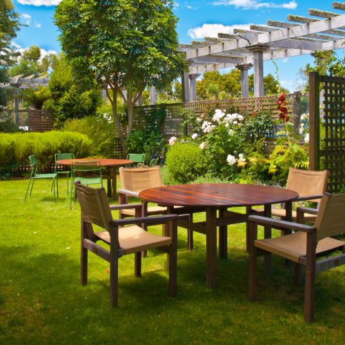 Landscaped Garden with Wooden Dining Table Set in the Shade of Trees